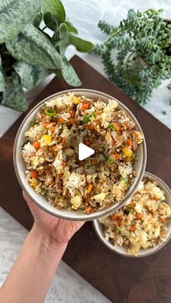 Maxine Sharf on Instagram: "Mom’s sheet pan Benihana fried rice✨

Fried Rice:▪️3 Cups Cooked, Cooled Jasmine Rice (from 1 cup uncooked rice)▪️1/3 Cup Finely Chopped Yellow Onion▪️1/4 Cup Finely Chopped Carrot▪️2 Scallions, sliced▪️1/2 tsp Kosher Salt▪️1/4 tsp Pepper▪️1 Tbsp Soy Sauce▪️1 Tbsp Sesame Seeds▪️2 Tbsp Toasted Sesame Oil▪️2 Eggs▪️

Garlic Butter:▪️1-2 Tbsp Butter▪️1 Garlic Clove, finely chopped▪️

1️⃣ Preheat the oven to 425F and line a sheet pan with parchment paper.
2️⃣ Spread the rice in an even layer and top with the onion, carrot, scallions, salt, pepper, soy sauce, sesame seeds, and sesame oil. (Make sure to drizzle some of the sesame oil around the edges of the rice for extra crispiness.)
3️⃣ In a small bowl, combine the garlic and butter. Microwave until melted (or melt in a pan), stir, and drizzle evenly over the rice.
4️⃣ Use two spoons to make two small wells in the rice, then crack an egg into each one.
5️⃣ Bake for 15 mins, until the rice is crisp at the edges and the eggs are cooked through. Slice the eggs into small pieces with two knives, then toss until evenly combined. Enjoy!

⏲10 minute prep time + 15 minute cook time

Recipe serves 4 as a side dish

For all recipes delivered to your inbox weekly (with printable PDFs) + access to the searchable recipe archive, subscribe to my newsletter via the link in my bio 😘"
