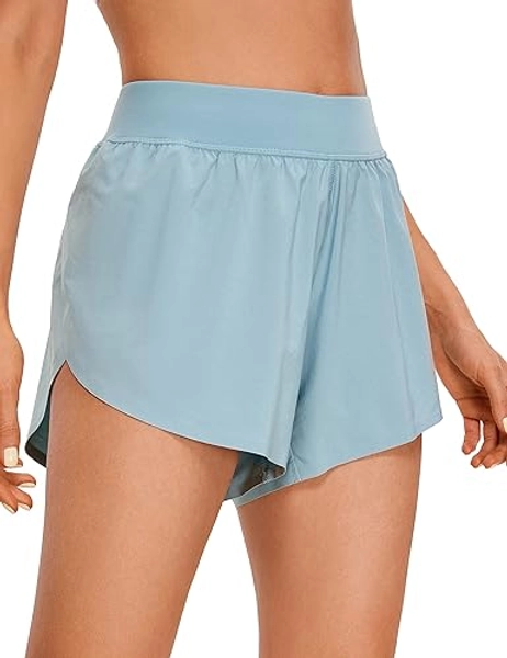 CRZ YOGA Mid Waisted Dolphin Athletic Shorts for Women 4" Lightweight High Split Gym Workout Shorts with Liner Quick Dry