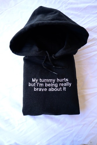 Embroidered 'My Tummy Hurts but I'm being Really Brave' Hoodie or Crew Neck, Long Sleeve, Classic fit, Unisex, Adult | Hooded Sweatshirt / Black / XX-Large