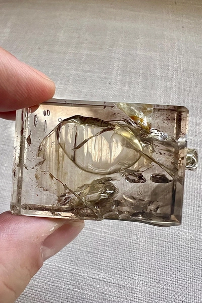 Enhydro - quartz rock crystal pendant - one large bubble and a smaller one in a crystal shaped cavity - ID A0487