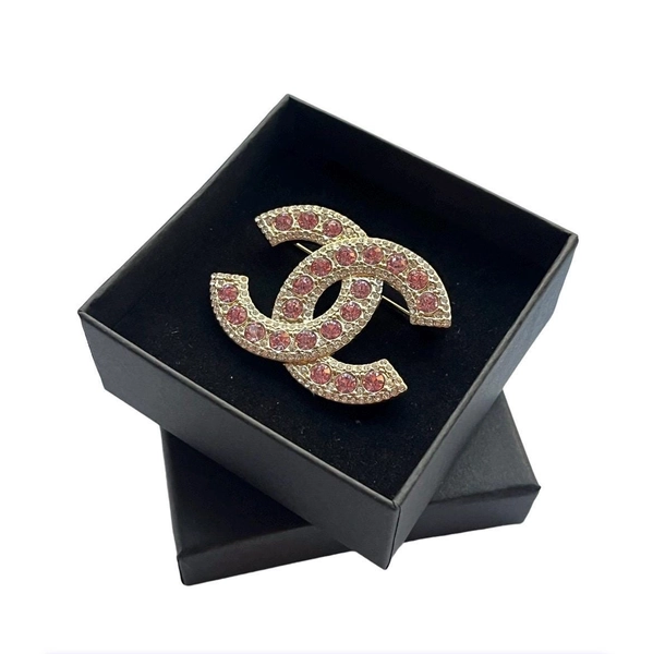 Vintage Chanel gold-tone brooch with pink crystals.