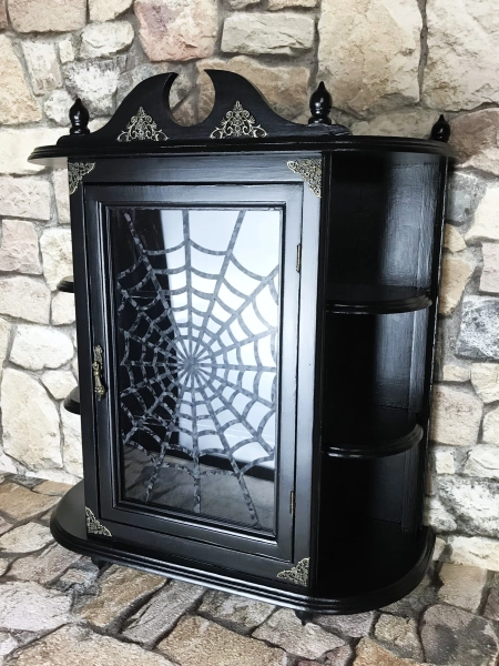 Gothic wooden display cabinet, a very special piece of furniture in elegant black with an integrated spider web