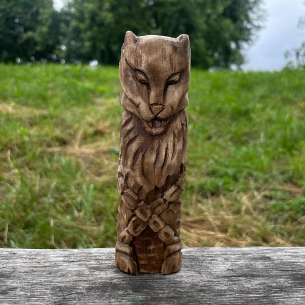Wooden statue - wolf Fenrir. Viking norse pagan god figurine. Paganism. Wooden statue scandinavian mythology. Sacred Valhalla. Wood carving.