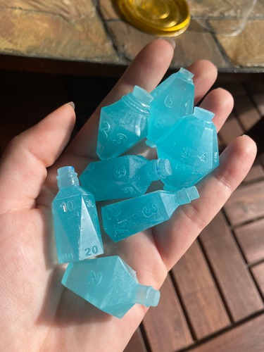 Glow in the dark blue solid bottle dice set