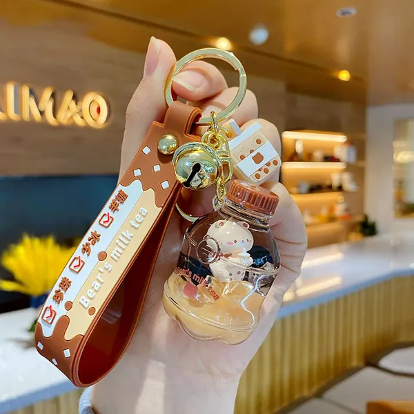 HSYHERE Men Women Creative Interesting Floating Milk Tea Brown Bear Lucky Bottle Keychain Keyrings, Bubble Tea Bear Moving Liquid Sand Car Key Chain Key Ring Bag Pendant Decoration Key Holder -Water Bottle