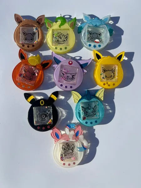 Anime poke eeveelution tomagotchi pop sockets, keychains, eevee, umbreon, flareon, leafeon, glaceon, vaporeon, espeon, jolteon, sylveon