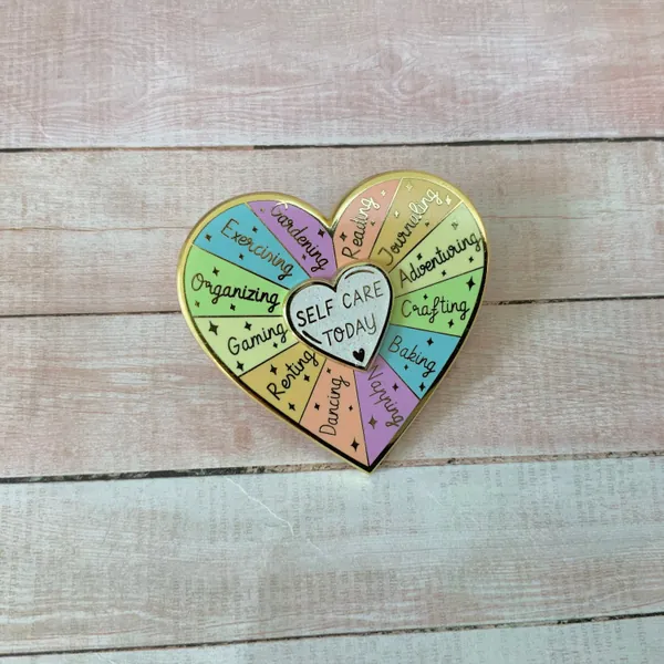 Beautiful hard Enamel spinning heart Pin with a self care message reminder, ideas for self care heart wheel interactive pin
